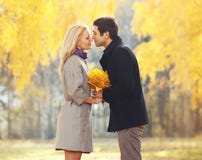 Portrait of young loving couple kissing in autumn stock image Portrait of young loving couple kissing in autumn stock image