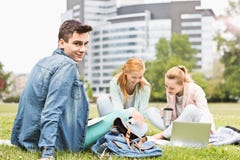 Portrait of young man with female friends studying on university campus Stock Photo Portrait of young man with female friends studying on university campus Stock Photo