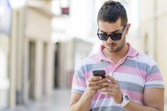 Portrait of young man sending message outdoor Stock Image Portrait of young man sending message outdoor Stock Image