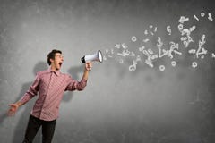 Portrait of a young man shouting using megaphone Stock Images Portrait of a young man shouting using megaphone Stock Images