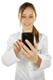 Portrait of a young smiling doctor using smartphone stock photography Portrait of a young smiling doctor using smartphone stock photography