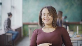 Portrait of young successful female employee. African woman entrepreneur worker in busy office, looks at camera, smile. Stock Images Portrait of young successful female employee. African woman entrepreneur worker in busy office, looks at camera, smile. Stock Images