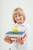 Portret szczęśliwy uczeń z książkami i jabłkiem odizolowywającymi na białym tle Edukacja, odizolowywająca Szkolny preschool fotografia stock Portret szczęśliwy uczeń z książkami i jabłkiem odizolowywającymi na białym tle Edukacja, odizolowywająca Szkolny preschool fotografia stock