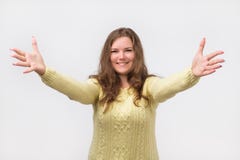 Portret van aantrekkelijke glimlachende Kaukasische vrouw dat op wapenshanden bij u wordt opgeheven Zij is gekleed in gele sweate royalty-vrije stock foto's Portret van aantrekkelijke glimlachende Kaukasische vrouw dat op wapenshanden bij u wordt opgeheven Zij is gekleed in gele sweate royalty-vrije stock foto's