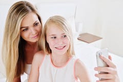 Porträt der schönen reifen Mutter und ihrer der Tochter, die ein selfie unter Verwendung des intelligenten Telefons und des Läche lizenzfreie stockbilder Porträt der schönen reifen Mutter und ihrer der Tochter, die ein selfie unter Verwendung des intelligenten Telefons und des Läche lizenzfreie stockbilder