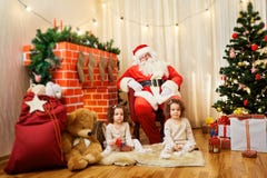 Porträt von Santa Claus- und Mädchendoppelbabys, Kind im Raum b stockbild Porträt von Santa Claus- und Mädchendoppelbabys, Kind im Raum b stockbild