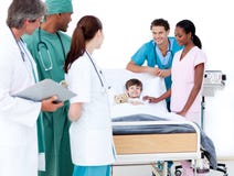 Positive medical team taking care of a little boy Stock Photos Positive medical team taking care of a little boy Stock Photos