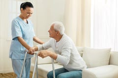 Positive Nice Woman Working As A Caregiver Stock Photo
