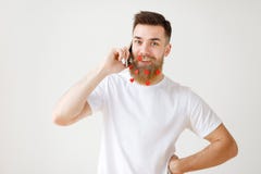 Positive pleasant looking bearded male model with long thick beard being satisfied to have phone conversation and relax stock photos Positive pleasant looking bearded male model with long thick beard being satisfied to have phone conversation and relax stock photos