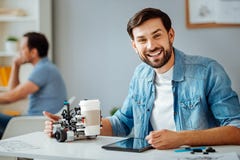 Positive professional engineer testing robot stock photos Positive professional engineer testing robot stock photos