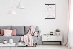 Poster above cabinet with plants in white flat interior with pin stock photos Poster above cabinet with plants in white flat interior with pin stock photos