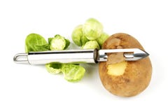Potato With Peelerand Sprouts Stock Photos