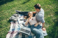 Potomstwa dobierają się w miłości odpoczywa na gazonie po nauki zdjęcie royalty free Potomstwa dobierają się w miłości odpoczywa na gazonie po nauki zdjęcie royalty free