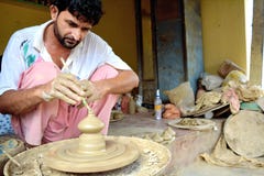 India Local Potter making pot on wheel