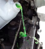 Pouring engine coolant into a car stock image Pouring engine coolant into a car stock image