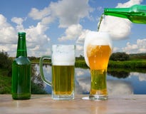 Pouring glass of beer from bottle royalty free stock images Pouring glass of beer from bottle royalty free stock images