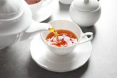 Pouring hot tea into porcelain cup Royalty Free Stock Photos Pouring hot tea into porcelain cup Royalty Free Stock Photos