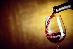 Pouring a single glass of red wine from a bottle stock image Pouring a single glass of red wine from a bottle stock image