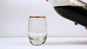 Pouring soda from the bottle into a glass stock images Pouring soda from the bottle into a glass stock images