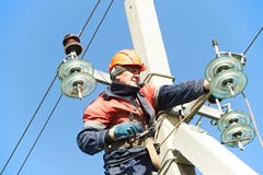 Power electrician lineman at work on pole