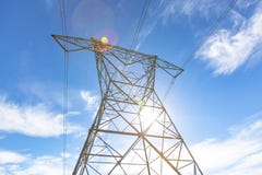 Power lines with the sun coming down and the blue sky above stock images Power lines with the sun coming down and the blue sky above stock images