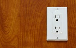 Power outlet on a wood grain surface. royalty free stock photos Power outlet on a wood grain surface. royalty free stock photos