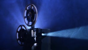 Powered old projector. Film rotates reels and vintage movie shows