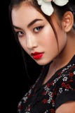 Pracowniana moda strzelał Azjatycka kobieta z białym kwiatem w włosy fotografia stock Pracowniana moda strzelał Azjatycka kobieta z białym kwiatem w włosy fotografia stock