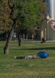 Prague, Czech Republic - September 10, 2019: bold Man sleeps on the grass in a sunny day at kampa park royalty free stock photography Prague, Czech Republic - September 10, 2019: bold Man sleeps on the grass in a sunny day at kampa park royalty free stock photography