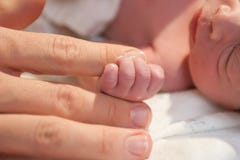 Preemie holding finger