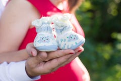 Pregnant couple holding hands in booties royalty free stock images Pregnant couple holding hands in booties royalty free stock images