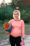 Pregnant fitness woman smiling at camera stock photos Pregnant fitness woman smiling at camera stock photos
