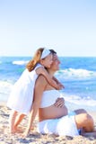 Pregnant mother and daughter on the beach royalty free stock images Pregnant mother and daughter on the beach royalty free stock images