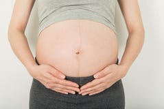 Pregnant Woman Belly holding hands on her stomach on white back royalty free stock images Pregnant Woman Belly holding hands on her stomach on white back royalty free stock images
