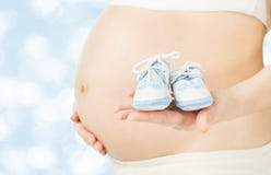 Pregnant Woman Belly With Newborn Baby Booties Pregnant Woman Belly With Newborn Baby Booties