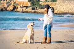 Pregnant woman enjoys her dog by the seaside royalty free stock photography Pregnant woman enjoys her dog by the seaside royalty free stock photography
