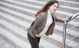 A pregnant woman feels pain on the street stock photo A pregnant woman feels pain on the street stock photo