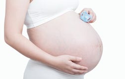 Pregnant woman hand holding pacifier for the unborn baby on whit Stock Photos Pregnant woman hand holding pacifier for the unborn baby on whit Stock Photos