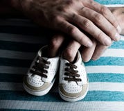 Pregnant Woman Holding Baby Shoes on her Belly royalty free stock image Pregnant Woman Holding Baby Shoes on her Belly royalty free stock image