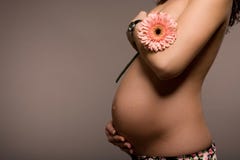 Pregnant woman holding a flower