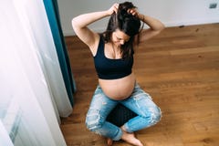 Pregnant woman at home smiling at baby belly Royalty Free Stock Photo Pregnant woman at home smiling at baby belly Royalty Free Stock Photo