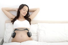 Pregnant woman - playing music to baby