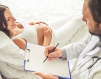 Pregnant woman visiting a doctor royalty free stock photo Pregnant woman visiting a doctor royalty free stock photo