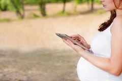 Pregnant Woman With Tablet PC Stock Photos