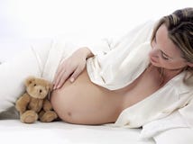 Pregnant Woman With Teddy Bear Royalty Free Stock Photography