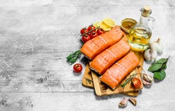 Prendedero de pescados de color salmón crudo con las especias, las hierbas y los tomates maduros imagen de archivo libre de regalías Prendedero de pescados de color salmón crudo con las especias, las hierbas y los tomates maduros imagen de archivo libre de regalías