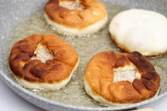 Preparation of belyashes. Traditional russian meat pies belyashi on a frying pan. Russian, Bashkir and Tatar cuisine royalty free stock photo Preparation of belyashes. Traditional russian meat pies belyashi on a frying pan. Russian, Bashkir and Tatar cuisine royalty free stock photo