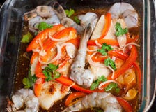 Raw tilapia fillets baked with shrimps and vegetables royalty free stock image Raw tilapia fillets baked with shrimps and vegetables royalty free stock image
