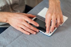 Preparing the screen for gluing a new protective glass. High angle top side profile view cropped photo male hands wipe screen wit royalty free stock photography Preparing the screen for gluing a new protective glass. High angle top side profile view cropped photo male hands wipe screen wit royalty free stock photography