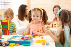 Preschool children play with colorful didactic toys at kindergarten stock photos Preschool children play with colorful didactic toys at kindergarten stock photos